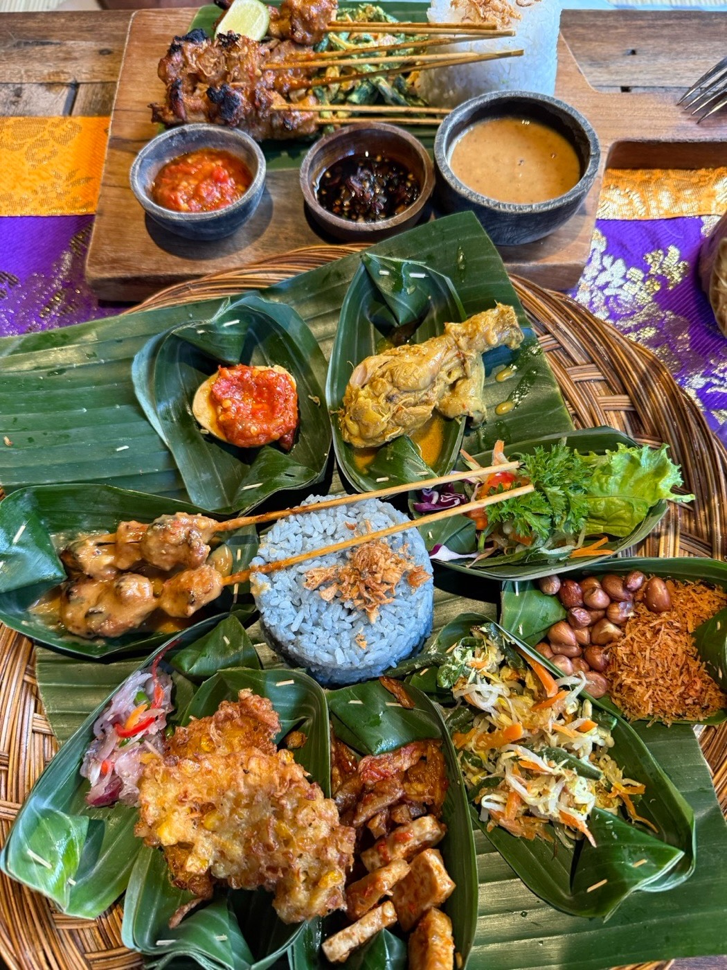 Balinese feast. Sate lilit, sambal and rice on banana leaves